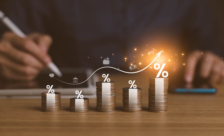 Nos Articles interest rates and dividends, investment returns, income, retirement compensation fund, investment, dividend tax. pile of coins and upward direction percentage symbol. saving money for investment